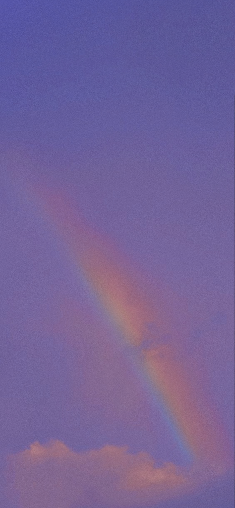 Fondo de pantalla aesthetic morado con un arcoiris en el cielo morado